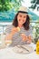 woman eating oysters in outdoors restaurant at sunny summer weather