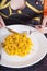 Woman eating paella with fork and knife