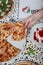 A woman is eating pepperoni pizza from the wood-fired oven. lunch in an italian restaurant.vertical image