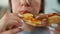 Woman eating pizza. Close-up. Concept of quick bites and unhealthy food