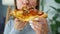 Woman eating pizza. Close-up. Concept of quick bites and unhealthy food