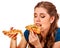 Woman eating pizza. Student consume fast food on table.