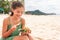 Woman eating poke bowl of ahi tuna on waikiki beach Hawaii. Local food fish salad vacation travel. Asian girl happy