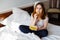 woman eating potato chips in bed home scared gaining weight