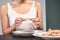 Woman eating or preparing pink prawns