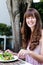 Woman eating salad, alfresco dining