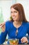 Woman eating salad with broccoli