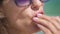 Woman eating strawberries near sea on sunny summer day. Closeup.