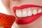 Woman eating strawberry, concept healthy teeth