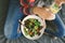 Woman eating summer salad vegetables flowers nasturtium violets