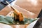 Woman eating sushi rolls at the table - close up photo. Traditional Japanese oriental kitchen with raw fish