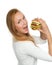 Woman eating tasty unhealthy burger cheeseburger sandwich