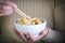 Woman eating three delights rice witn chopsticks