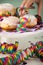 Woman eating traditional German Berliner Pfannkuchen Krapfen doughnuts to celebrate carnival or new yearÂ´s eve with colorful