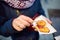 Woman eating traditional Poland street food oscypek on Christmas market in Krakow. Oscypek is a grilled cheese of salted sheep