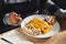 Woman eating traditional venezuelan christmas dish with hallacas, pan de jamon or ham bread, and mixed salad, with cutlery and