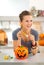 Woman eating trick or treat candy in halloween decorated kitchen