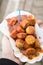 Woman eating typical German Currywurst street food is grilled and sliced sausage with curry ketchup in paper plate on the go