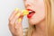 Woman eating yellow macaroon