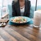 Woman eats healthy food, Caesar salad and a milkshake