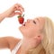 Woman eats strawberry