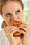 Woman eats unhealthy food, hamburger