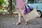 Woman with eco bag from sackcloth with pink and purple flowers