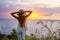 Woman on the edge of a cliff and looking at sunset, Nusa Penida