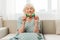 Woman elderly christmas mature home grandmother couch happiness holiday glasses pensioner