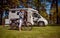 Woman on electric bike resting at the campsite VR Caravan car Va