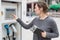 Woman at an electric car charging station