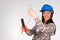 A woman electrician repairs a light with a light bulb in hands and looks with a smile at the camera. White background