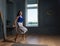 Woman in elegant clothes jumping in a room with modern interior