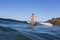 A woman elegantly cross-steps on a longboard at an isolated surf break in Australia
