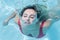 Woman emerging from swimming underwater at the pool