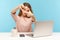 Woman employee, designer or photographer sitting, at workplace with laptop making photo frame with hands