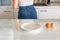 Woman with empty plate on the kitchen table, eggs and glass of milk ready cooking breakfast.