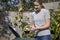 Woman Emptying Food Waste Into Garden Composter At Home