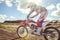 Woman on enduro motocross in motion, desire for victory, dynamics of speed