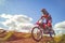 Woman on enduro motocross in motion, desire for victory, dynamics of speed