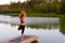 A woman is engaged in physiotherapy exercises on the lake in nature. The concept of treating diseases