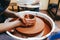 Woman is engaged in pottery. Potter in the process of creating a clay product