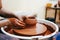 Woman is engaged in pottery. Potter in the process of creating a clay product