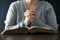 Woman engaged in prayer. In the quiet darkness of a sacred room, she seeks solace, spiritual connection. Immerse yourself in the