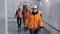 Woman engineer colleagues walk along electrical substation