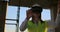 A woman engineer at a construction site in virtual reality glasses moves her hands simulating the work of the interface