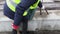 Woman Engineer with hammer near building materials concrete blocks