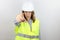 Woman engineer with hardhat pointing displeased and frustrated to the camera, angry and furious at you.
