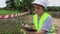 Woman engineer holding folder and writing