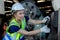 Woman engineer wear hardhat working at machine in factory. female technician control metalwork lathe industrial. female employee